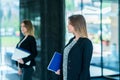 Handsome confident business woman holding files. Portrait of a h Royalty Free Stock Photo