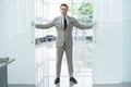 Handsome confident businessman in suit entering the office. Royalty Free Stock Photo