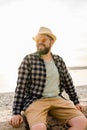 Handsome and confident. Outdoor portrait of smiling man wearing hat and sunglasses on beach. Holidays travel and summer Royalty Free Stock Photo