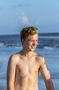 Handsome confident teenager in sunset at the beach