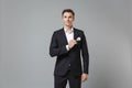 Handsome confident young business man in classic black suit shirt posing isolated on grey background studio portrait Royalty Free Stock Photo