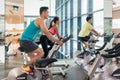 Handsome and confident young man during group class of HIIT indoor cycling Royalty Free Stock Photo