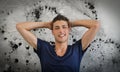 Handsome and confident young man smiling, spotted wall behind him Royalty Free Stock Photo