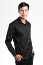 Handsome confident young man standing and smiling in a black shirt. on white background Royalty Free Stock Photo