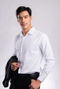 Handsome confident young man standing and smiling in a white shirt on white background Royalty Free Stock Photo