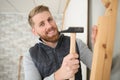 handsome construction man using hammer to nail wood Royalty Free Stock Photo
