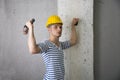 Handsome construction worker with hard hat and hammer