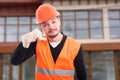 Handsome constructor showing call me hand sign