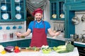 Handsome cook invites to cooking. Man prepared vegetables for cooking with love. Guy welcomes to kitchen.