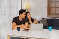 Handsome couples teach a disabled lover to sit in a chair together at home. Royalty Free Stock Photo