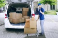 Courier with packages shows thumb up Royalty Free Stock Photo