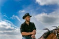 Handsome cowboy, horse rider on saddle, horseback adn boots Royalty Free Stock Photo