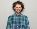 handsome curly hair man with glasses in checkered shirt smiling Royalty Free Stock Photo