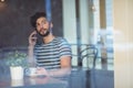 Handsome customer talking on cellphone at cafe Royalty Free Stock Photo