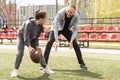 Handsome dad with his little cute daughter are having fun and playing American football on green grassy lawn Royalty Free Stock Photo