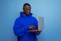 handsome dark-skinned 25 year old american freelancer in stylish hoodie with laptop on background with copy space Royalty Free Stock Photo