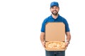 handsome delivery man holding pizza in box and smiling at camera Royalty Free Stock Photo