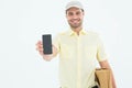 Handsome delivery man showing mobile phone