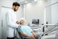 Dentist with elder woman before the procedure in the dental office Royalty Free Stock Photo