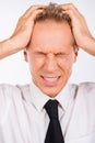 Handsome depressed businessman in business suit holding his head Royalty Free Stock Photo