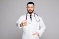 Handsome doctor with open hands giving pills on white background Royalty Free Stock Photo