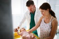 Doctor pediatrician with mother and baby child in clinic. Hospital, examining, child concept. Royalty Free Stock Photo