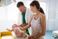 Doctor pediatrician with mother and baby child in clinic. Hospital, examining, child concept. Royalty Free Stock Photo