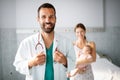 Doctor pediatrician with mother and baby child in clinic. Hospital, examining, child concept. Royalty Free Stock Photo