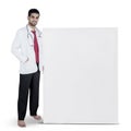 Handsome doctor standing besides blank board Royalty Free Stock Photo