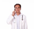 Handsome doctor talking on his cellphone Royalty Free Stock Photo