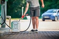 Handsome driver refueling canister with gasoline.