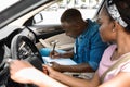 Handsome driving instructor taking notes while exam