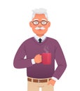 Handsome elderly gray-haired man with a mustache and glasses is holding a cup of hot coffee. Old grandpa at breakfast. Portrait of