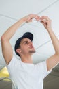 Handsome electrician changing lightbulb Royalty Free Stock Photo