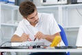 Handsome electrician testing induction hobs Royalty Free Stock Photo