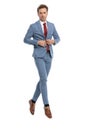 Handsome elegant businessman buttoning blue suit and jumping