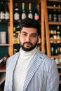 Handsome elegant man against wall of wine bar. Royalty Free Stock Photo