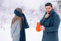Handsome elegant man, finger to mouth - tsss gesture, surprise for his girlfriend holding red heart, greeting card with Royalty Free Stock Photo