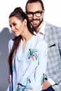 Handsome elegant man in glasses in suit with beautiful woman in colorful dress Royalty Free Stock Photo