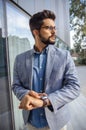 Handsome elegant man standing in front of office