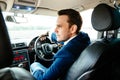 Attractive handsome elegant man in a business suit driving an expensive car Royalty Free Stock Photo