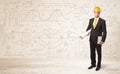 Handsome engineer calculating with hand drawn background