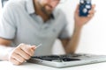 Handsome engineer repairing laptop computer. Royalty Free Stock Photo