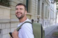 Handsome entrepreneur walking with his elegant backpack