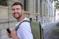 Handsome entrepreneur walking with his elegant backpack