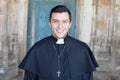 Handsome ethnic catholic priest smiling