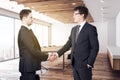 Handsome european businessmen shaking hands