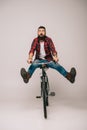 Handsome excited man riding bike isolated