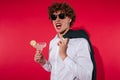 Handsome excited man in white shirt and jacket holding cocktail