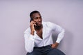 Handsome excited young african business man with mobile phone isolated over gray background Royalty Free Stock Photo